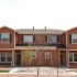 A red condominium with a gravel yard. | Rental houses by Peterson AFB, Colorado Springs, CO
