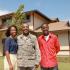 Airman with woman and teenager in front of home | Hickam Communities | Hickam Communities