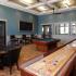 Shuffle board and game room in off-campus student apartment with community clubhouse in Mobile, AL