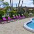 Swimming Pool with lounge chairs and tables. | Advenir at Cocoplum