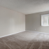 Spacious bedroom with beige walls and brand new carpet
