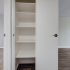 Additional hallway closet with ample storage space and stacked shelving