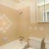 Photo showing bathroom with tub, toilet, sink, tiled walls, and medicine cabinet.,