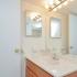 Spacious master bathroom with overhead lighting and large mirror