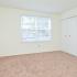 Carpeted bedroom with a large window at Willow Run Apartments in Willow Grove, PA.
