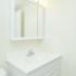 Model bathroom with lighted vanity sink at Willow Run Apartments in Willow Grove, PA.