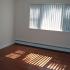Large window and hardwood flooring in bedroom at Lansdale Village Apartments