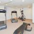 Fitness center with 2 treadmills, an elliptical and weights at Suburban Court Apartments in Ardmore, PA.