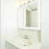 Bedroom with ample lighting and a white vanity at Fox Run apartments for rent in Warminster, PA