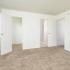 Carpeted bedroom with a large window and closet at Woodland Plaza Apartments in Wyomissing, PA.