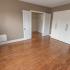 Bedroom with hardwood flooring and white closets at Delfe Apartments at Trolley Square in Wilmington, DE
