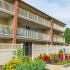 Exterior view of a residential building surrounded by flowers at Black Hawk apartments for rent in Downingtown, PA