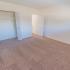 Bedroom with beige carpet and a closet at Black Hawk apartments for rent
