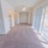 Dining room with beige carpet, a closet, ceiling fan, and balcony views at Black Hawk apartments in Downingtown, PA