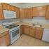 Kitchen with tiled flooring and modern appliances at Mayflower Crossing Apartments in Wilkes-Barre, PA.