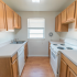 Kitchen with a sunny window and white appliances at Evergreen Club apartments for rent in Broomall, PA