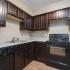 kitchen with black appliances at Silver Springs Apartments in Springfield MO