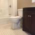 Homeroom Lofts Apartments, interior, bathroom, dark cabinet, tile floor, toilet, shower/tub