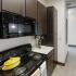 The Venue at North Campus-Interior | Kitchen with Stove, Over Stove Microwave and Refrigerator
