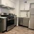 renovated kitchen with stainless steel appliances and grey and white cabinets