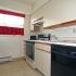 Kitchen with white cabinetry and tiled flooring at The Commons at Fallsington apartments for rent